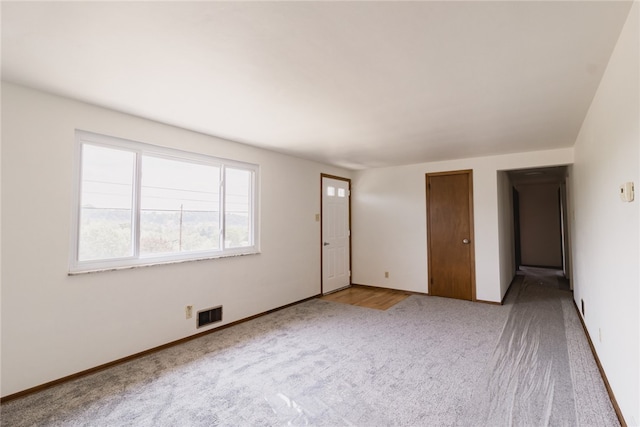 spare room with light colored carpet