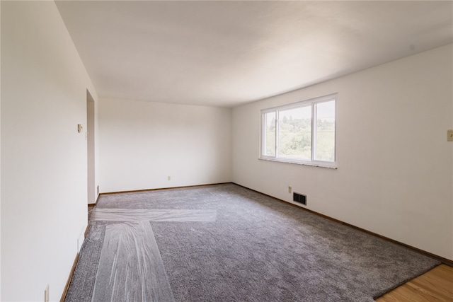 spare room with hardwood / wood-style flooring