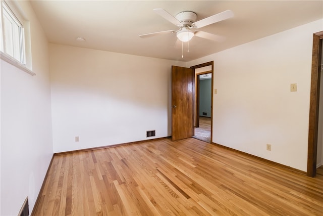 empty room featuring ceiling fan and light hardwood / wood-style floors