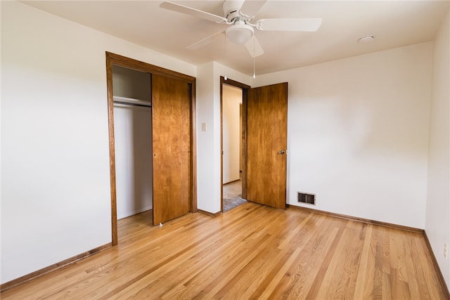 unfurnished bedroom featuring ceiling fan, light hardwood / wood-style flooring, and a closet