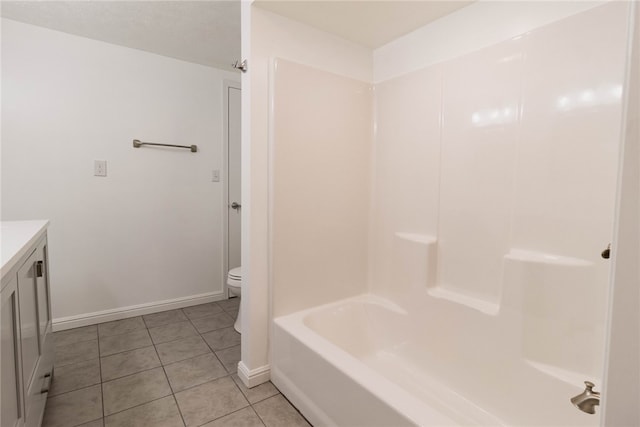 full bathroom featuring a textured ceiling, shower / washtub combination, toilet, vanity, and tile patterned flooring