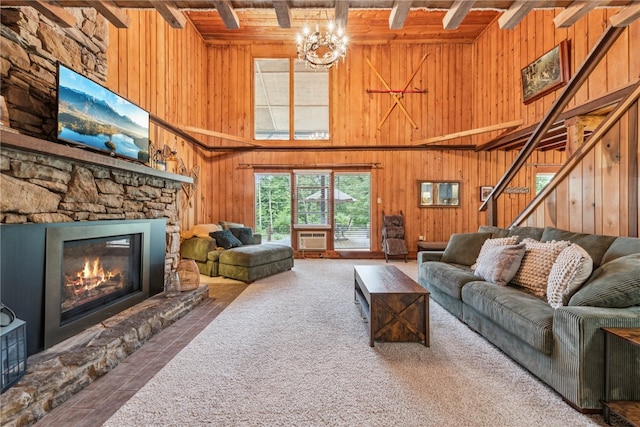 living room with a stone fireplace, beamed ceiling, and wooden walls