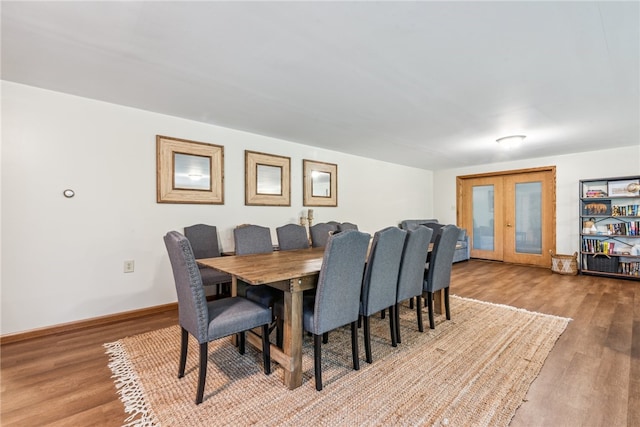 dining space featuring french doors and hardwood / wood-style flooring