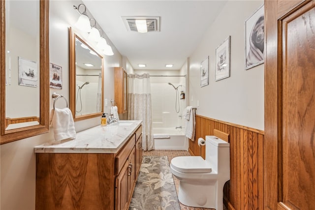 full bathroom with shower / bath combo with shower curtain, tile patterned floors, vanity, and toilet