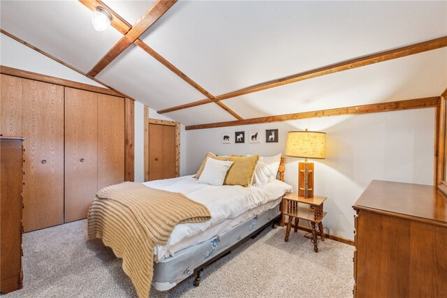 bedroom with light carpet and vaulted ceiling