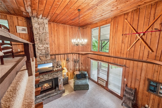 living area featuring wood walls, carpet floors, and wood ceiling