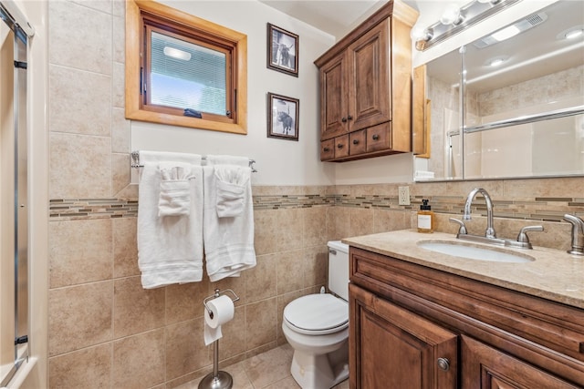 bathroom with toilet, tile walls, backsplash, tile patterned flooring, and vanity