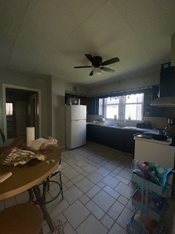 kitchen featuring white fridge, light tile patterned floors, and ceiling fan