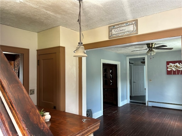 interior space featuring ceiling fan, hardwood / wood-style flooring, a textured ceiling, and a baseboard radiator