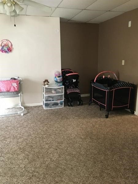 bedroom with a paneled ceiling and carpet