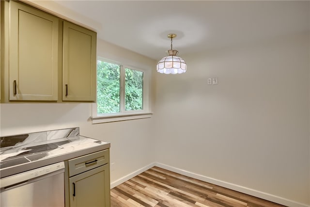 kitchen with dishwashing machine, light wood-type flooring, and decorative light fixtures