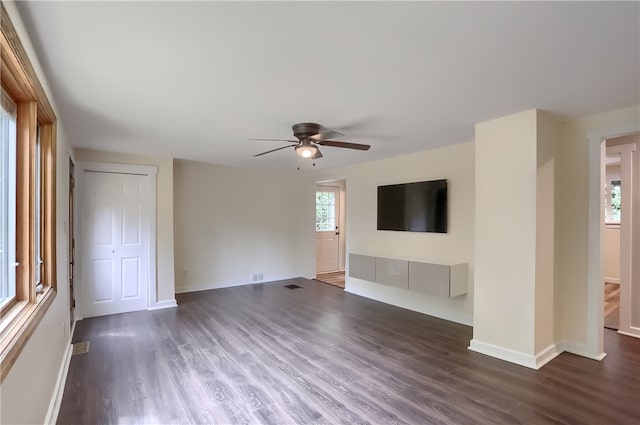 unfurnished living room featuring ceiling fan and hardwood / wood-style flooring