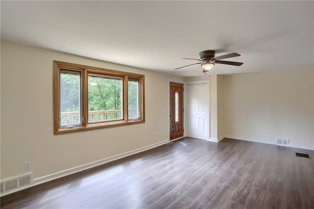 unfurnished room with ceiling fan and dark hardwood / wood-style flooring