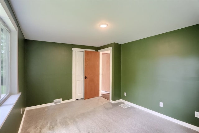 unfurnished bedroom with light carpet