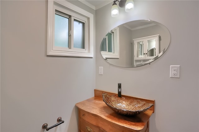 bathroom with ornamental molding and vanity