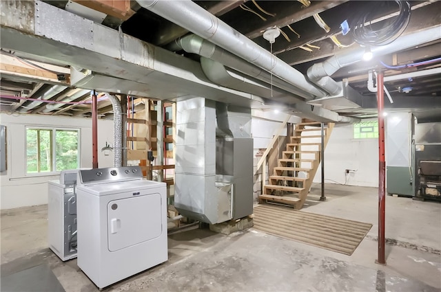 basement featuring separate washer and dryer and heating unit