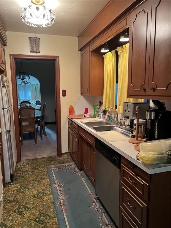 kitchen featuring sink, stainless steel appliances, and dark brown cabinets