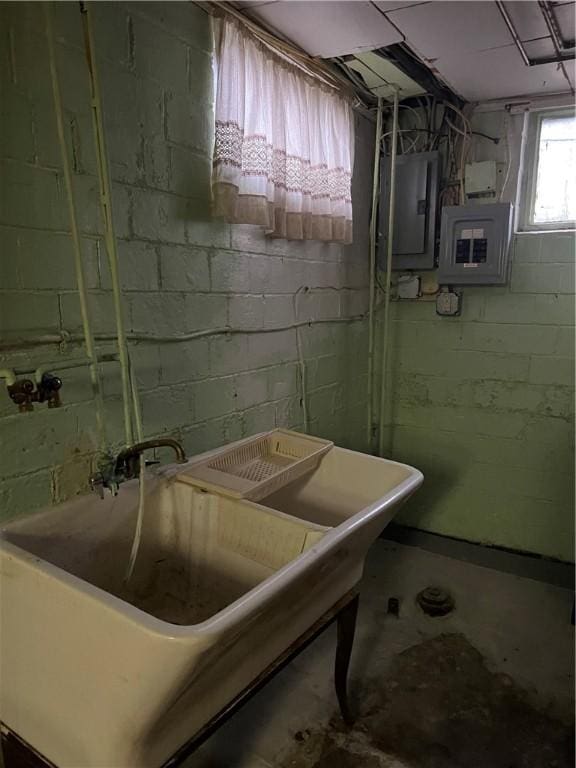 basement featuring electric panel and sink