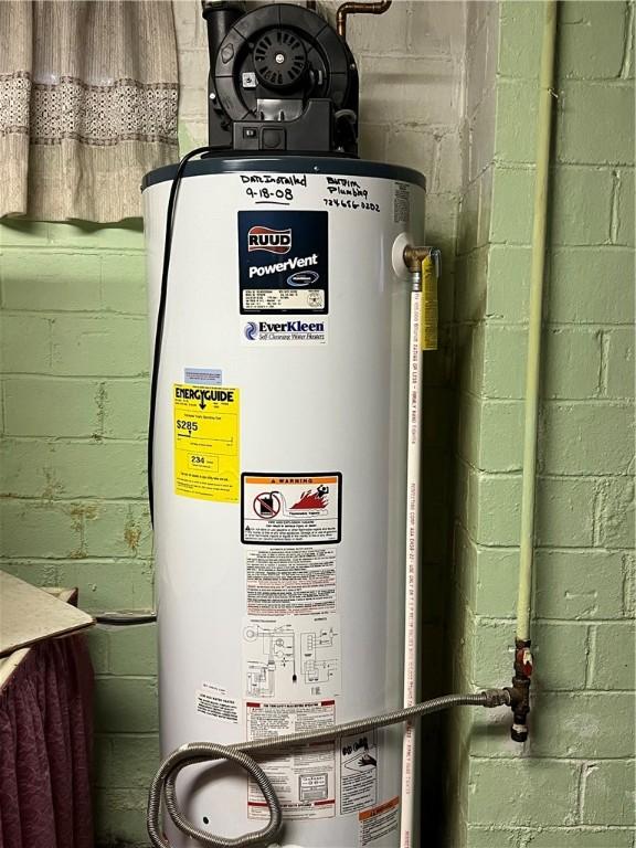 utility room featuring gas water heater