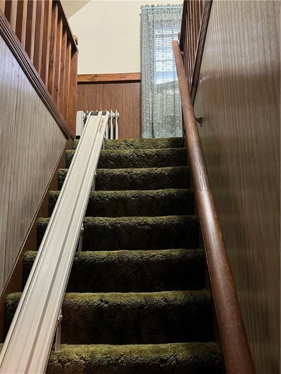 stairs featuring wooden walls