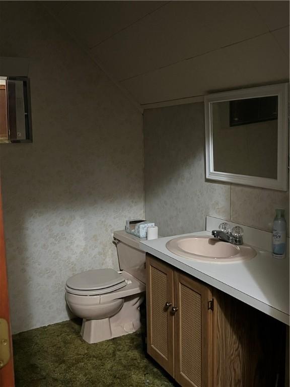 bathroom featuring vanity and toilet