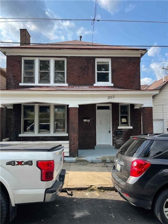 view of front of property featuring covered porch and brick siding