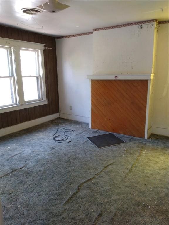 unfurnished living room with carpet floors and visible vents