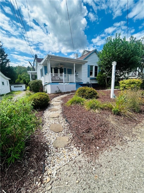 rear view of house featuring covered porch