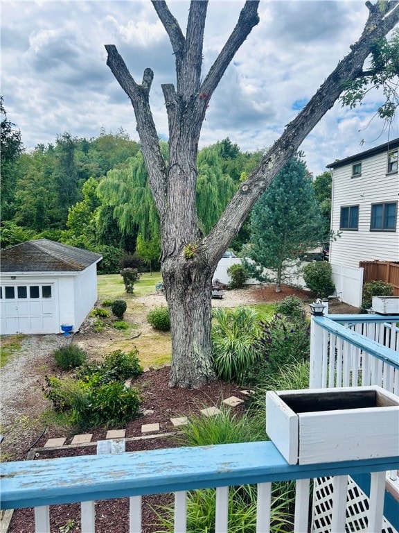 view of yard featuring a garage and an outbuilding