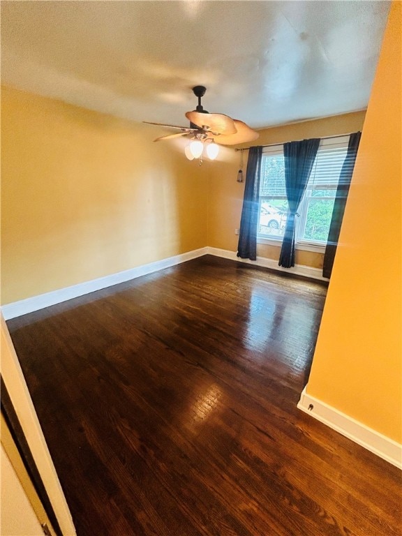 unfurnished room with ceiling fan and dark hardwood / wood-style flooring