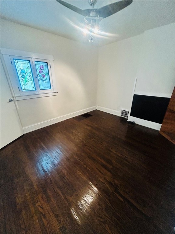 spare room with hardwood / wood-style floors and ceiling fan