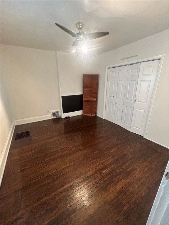 unfurnished bedroom featuring ceiling fan, hardwood / wood-style flooring, and a closet