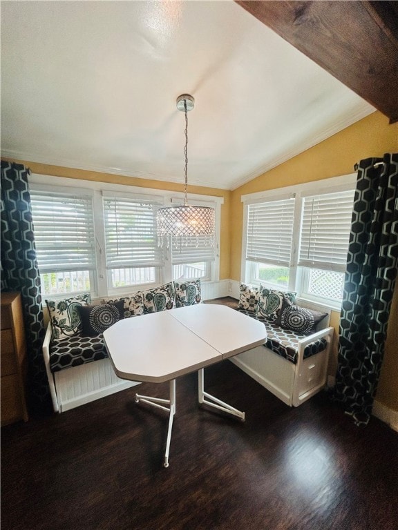 dining area featuring lofted ceiling, crown molding, dark hardwood / wood-style flooring, and a wealth of natural light