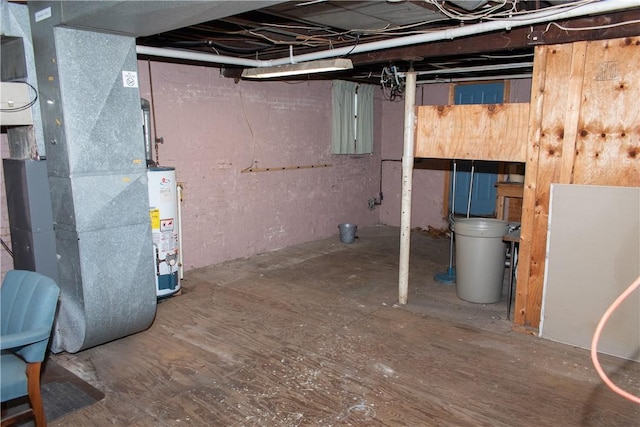 basement featuring heating unit and water heater