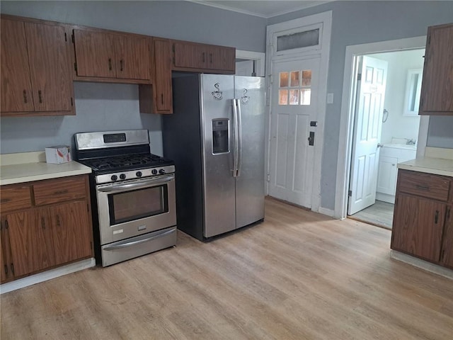 kitchen with appliances with stainless steel finishes and light wood-type flooring