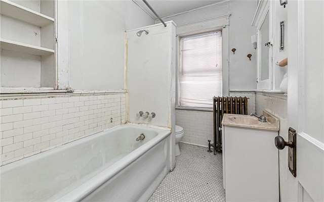 full bathroom with a wealth of natural light, vanity, toilet, and radiator