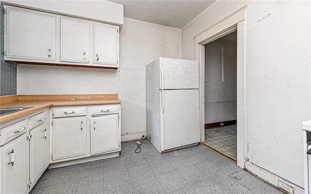 kitchen with white cabinets and white refrigerator