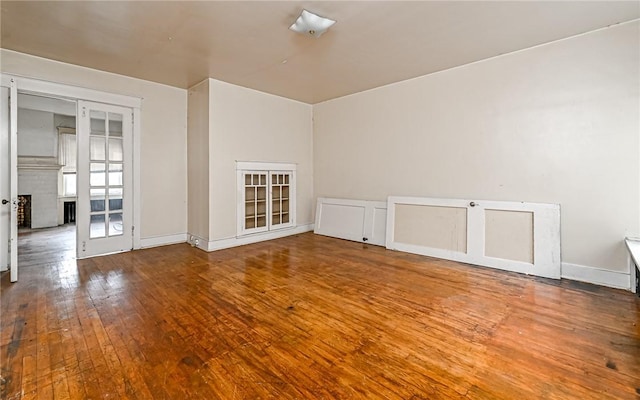 spare room with hardwood / wood-style floors and french doors