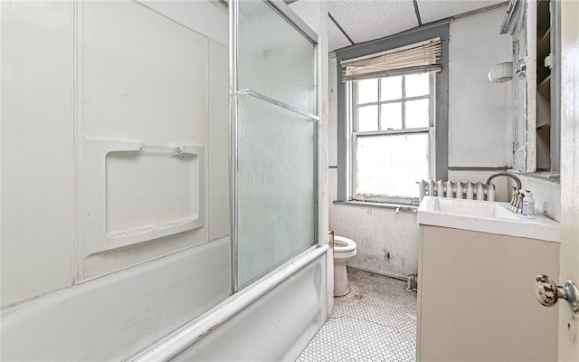 full bathroom featuring a paneled ceiling, vanity, toilet, and shower / bath combination with glass door