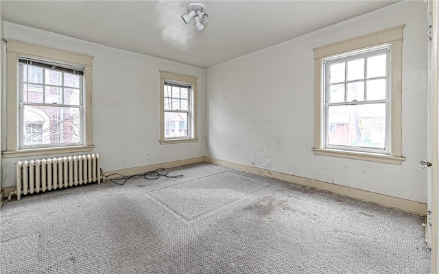 carpeted spare room with radiator