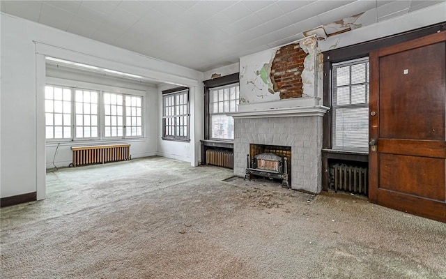 unfurnished living room with carpet flooring and radiator heating unit