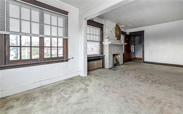 unfurnished living room with carpet and radiator heating unit