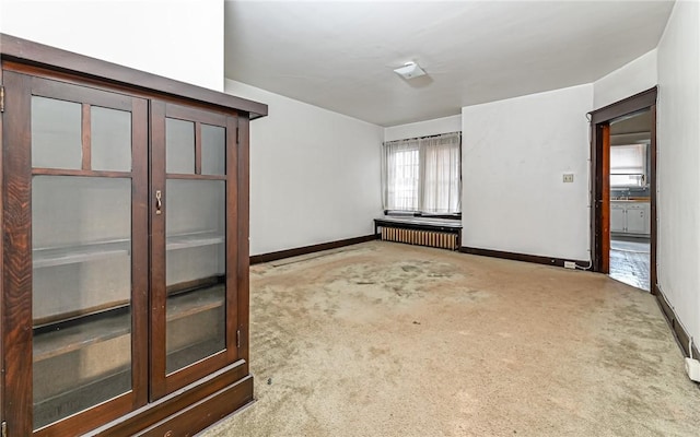 carpeted spare room with radiator