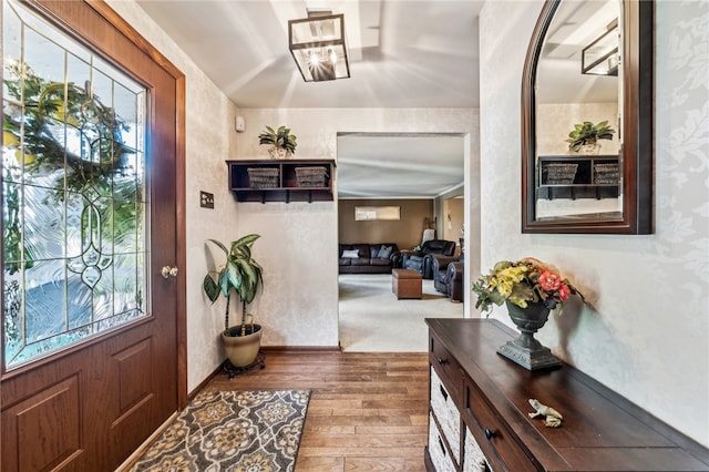 foyer entrance featuring a healthy amount of sunlight and carpet floors