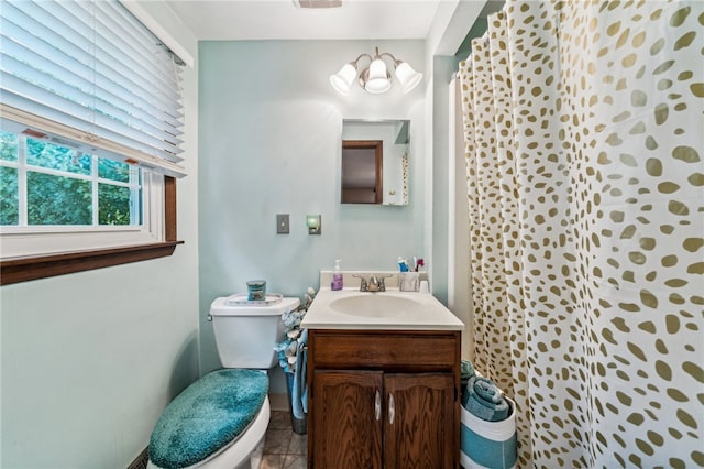 bathroom featuring tile patterned floors, vanity, and toilet