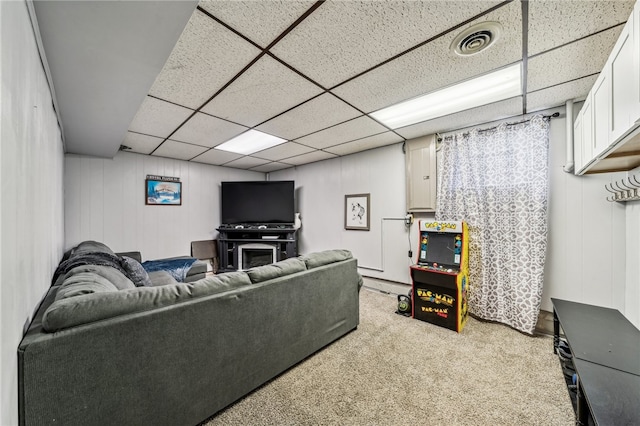 carpeted living room featuring a paneled ceiling