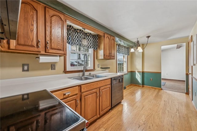 kitchen featuring sink, light hardwood / wood-style flooring, dishwasher, pendant lighting, and electric stove