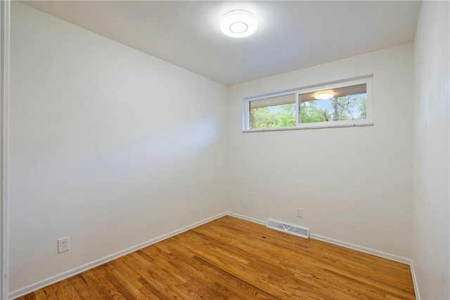 spare room with wood-type flooring