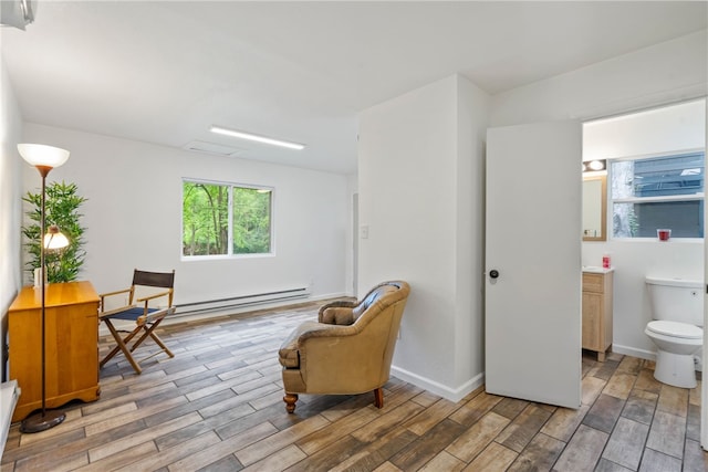 3326 New England Rd, West Mifflin, PA 15122 - living area featuring light wood finished floors, a baseboard radiator, and baseboards