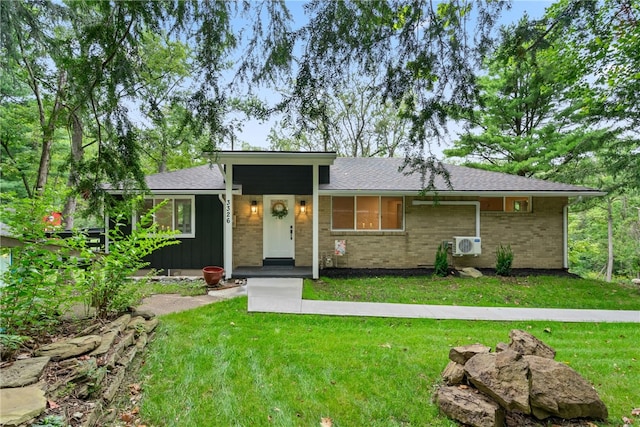 3326 New England Rd, West Mifflin, PA 15122 - view of front of house with a front lawn, ac unit, brick siding, and board and batten siding